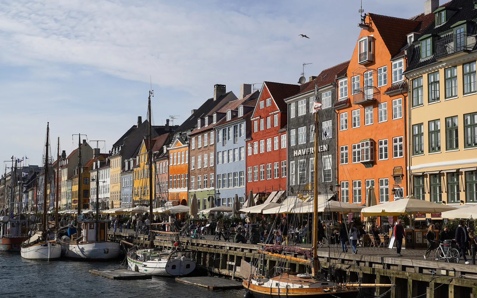Colorful historic facades and boats along Nyhavn in Copenhagen