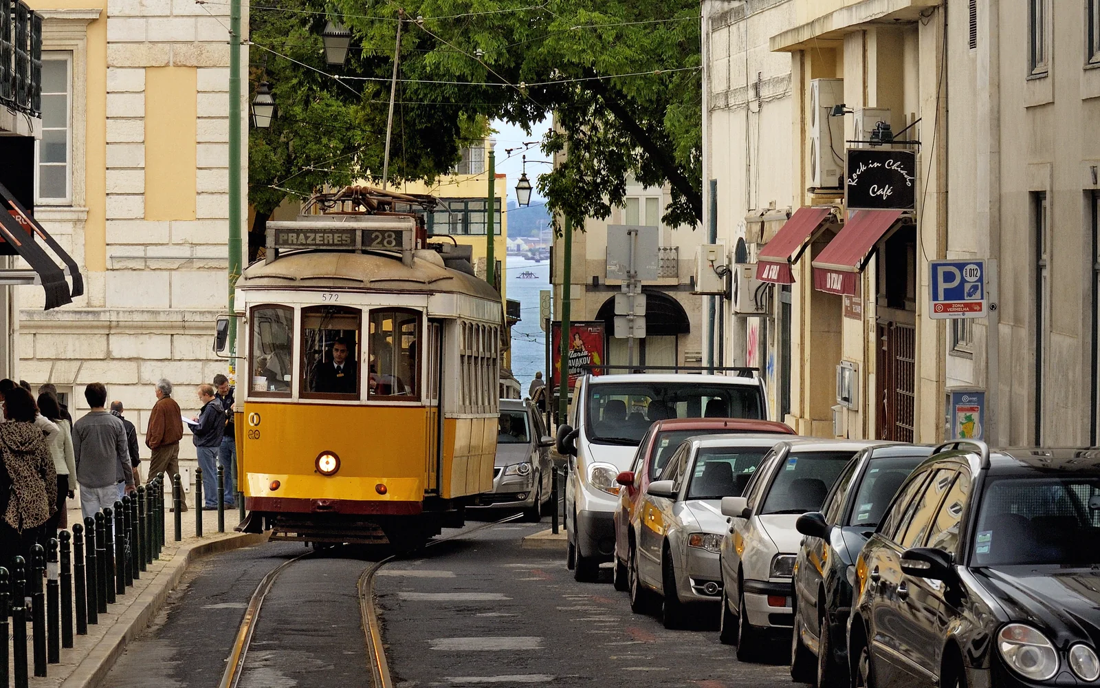 Yellow Tram 28 traveling along a Lisbon street